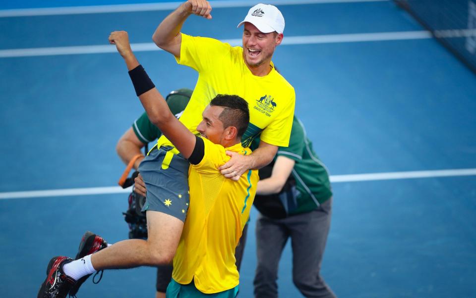 Nick Kyrgios of Australia carries team captain Lleyton Hewitt as they celebrate Australia's victory over the US after Kyrgios' match against Sam Querrey in the world group quarter-final Davis Cup clash between Australia and the USA in Brisbane - PATRICK HAMILTON/AFP/Getty Images