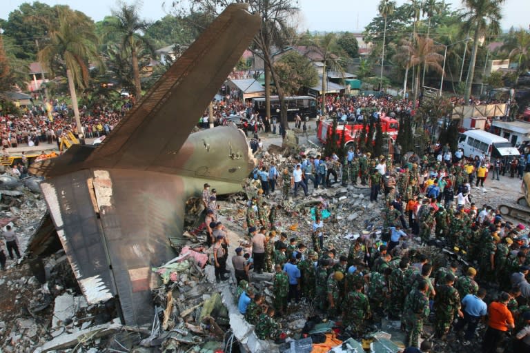 Search and rescue teams at the site of an Indonesian military C-130 Hercules aircraft crash in Medan on June 30, 2015