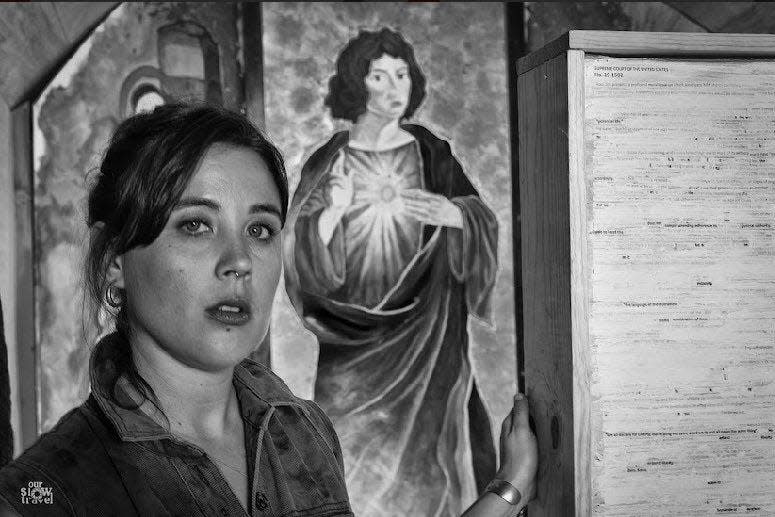 Jackie DesForges, creator behind the Church of Potential Life, stands in front of her altar during the project's inaugural mass.