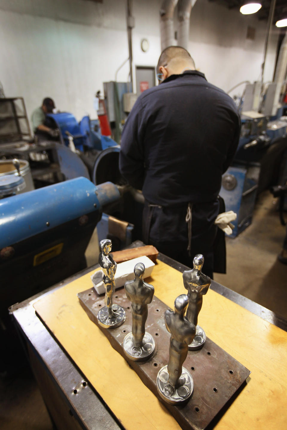 CHICAGO, IL - FEBRUARY 09: Eladio Gonzalez polishes an Oscar statuette at R.S. Owens & Company February 9, 2012 in Chicago, Illinois. R.S. Owens manufactures the Oscar statuettes which are presented at the annual Academy Awards by the Academy of Motion Picture Arts and Sciences. After the theft of the statuettes prior to the 2000 Academy Awards the company began casting the statuettes one year in advance of the show. (Photo by Scott Olson/Getty Images)