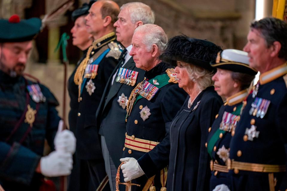 The queen's second son, Prince Andrew (third from left), wore a suit to escort the queen's coffin, with a slightly flashy appearance.  (AP)