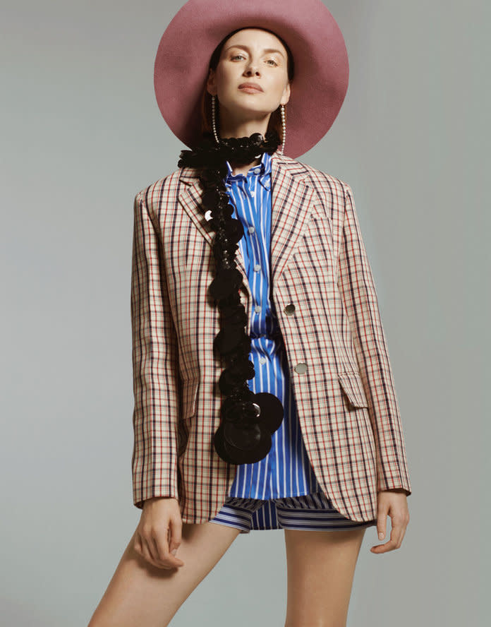 <p>Prada jacket, shirt, shorts, and scarf. Valentino Garavani hat. Mizuki earrings. Photo by Philip Gay/2DM</p>