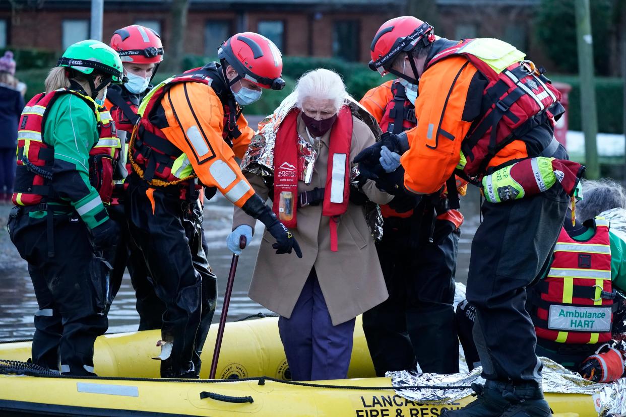 <p>A man wades through the flood waters in Northwich</p> (Getty)