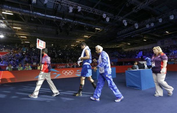 Olympic judges and referees came under fire with one fighter accusing them of "a fix," another successfully appealing a loss and even boxing great Lennox Lewis questioning some of their calls. Iran's Ali Mazaheri cried foul when the heavyweight was disqualified after being warned three times for persistent holding against Cuban Jose Larduet Gomez despite leading by two points going into the second round.