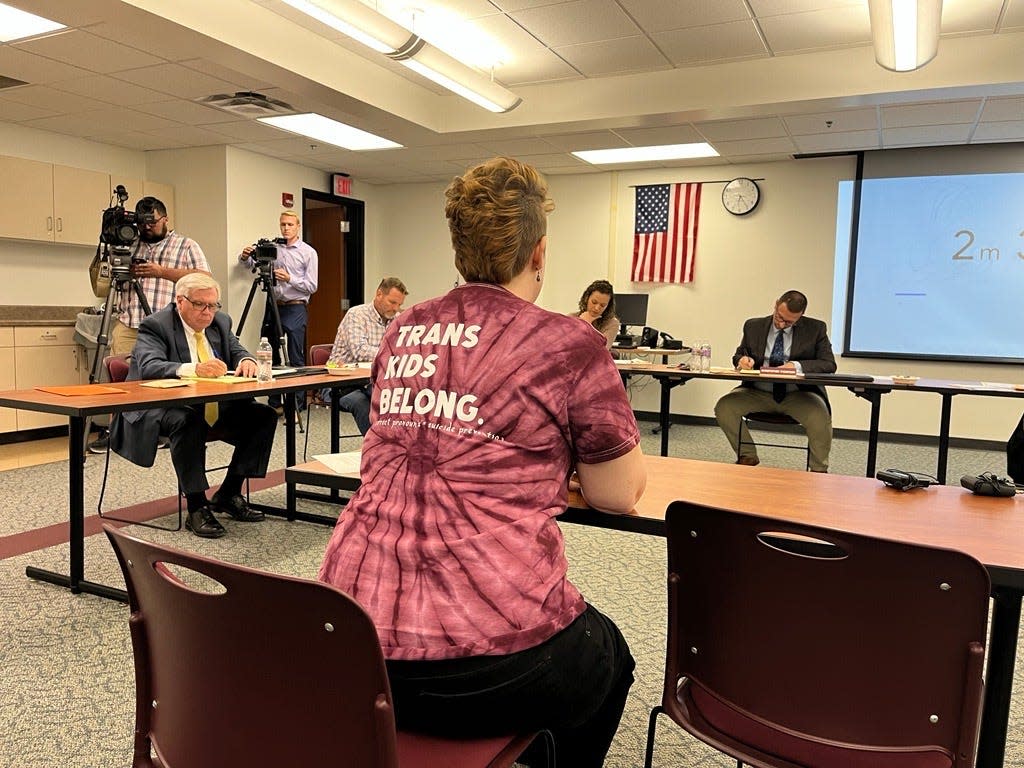 Erica Stindt speaks at a De Pere School Board meeting opposing a flag banning policy on Monday in De Pere. Her shirt reads "Trans Kids Belong."