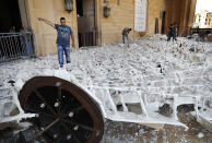 People remove debris from a damaged mosque a day after an explosion hit the seaport of Beirut, Lebanon, Wednesday, Aug. 5, 2020. Residents of Beirut confronted a scene of utter devastation on Wednesday, a day after a massive explosion at the port rippled across the Lebanese capital, killing at least 100 people, wounding thousands and leaving entire city blocks flooded with glass and rubble. (AP Photo/Hussein Malla)