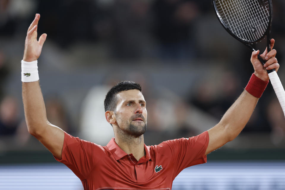 FILE - Serbia's Novak Djokovic plays the crowd during his third round match of the French Open tennis tournament against Italy's Lorenzo Musetti at the Roland Garros stadium in Paris, Sunday, June 2, 2024. Novak Djokovic withdrew from the French Open with an injured right knee on Tuesday, June 4, 2024, ending his title defense and meaning he will relinquish the No. 1 ranking. (AP Photo/Jean-Francois Badias, File)