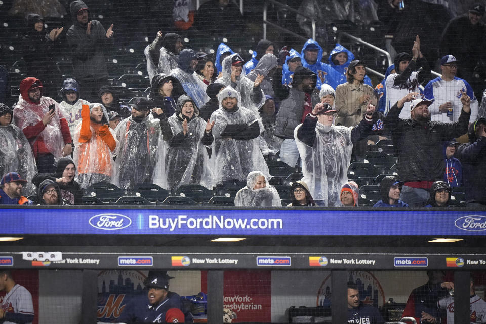 Atlanta Braves fans celebrate after Matt Olson hit a home run during the fifth inning of the team's baseball game against the New York Mets, Friday, April 28, 2023, in New York. (AP Photo/Bryan Woolston)