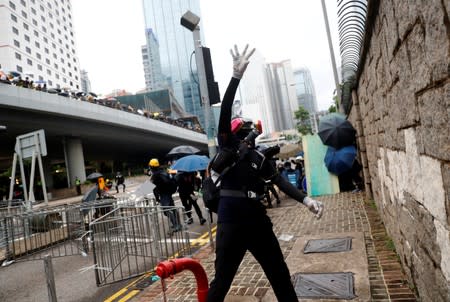 A demonstrator throws an object during a protest in Hong Kong