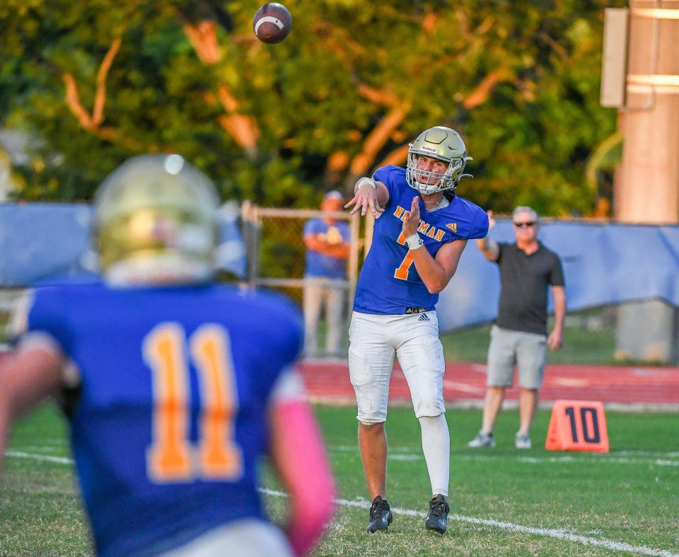 Cardinal Newman quarterback Luke Warnock (7) throws a pass to wide receiver Chris Presto (11) during the second quarter of a 40-7 victory over John Carroll Monday night in West Palm Beach.