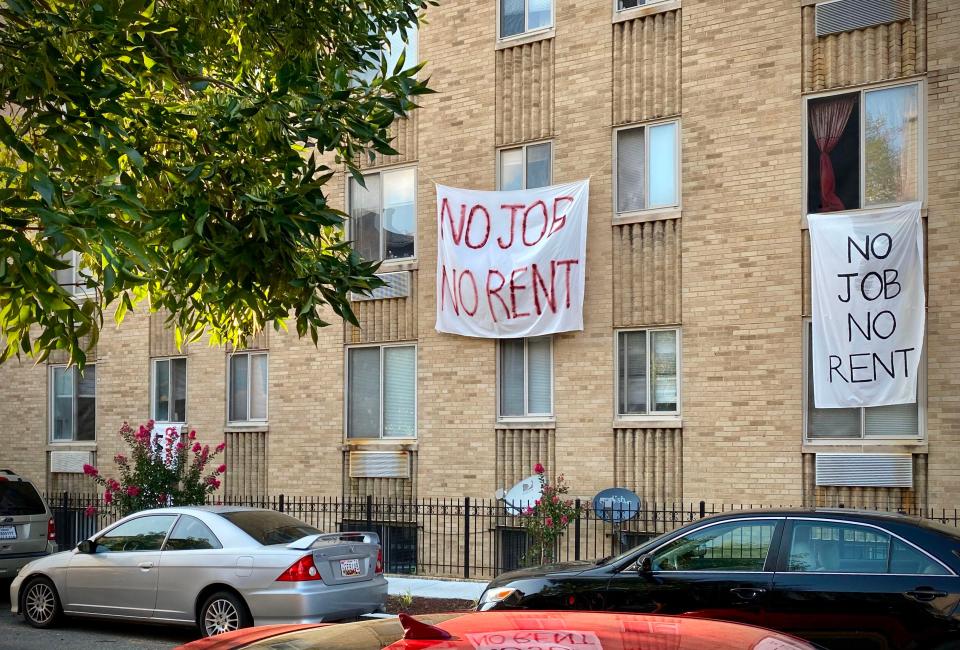 Banner against renters eviction reading, "No job, no rent," is displayed on a controlled rent building in Washington, D.C.