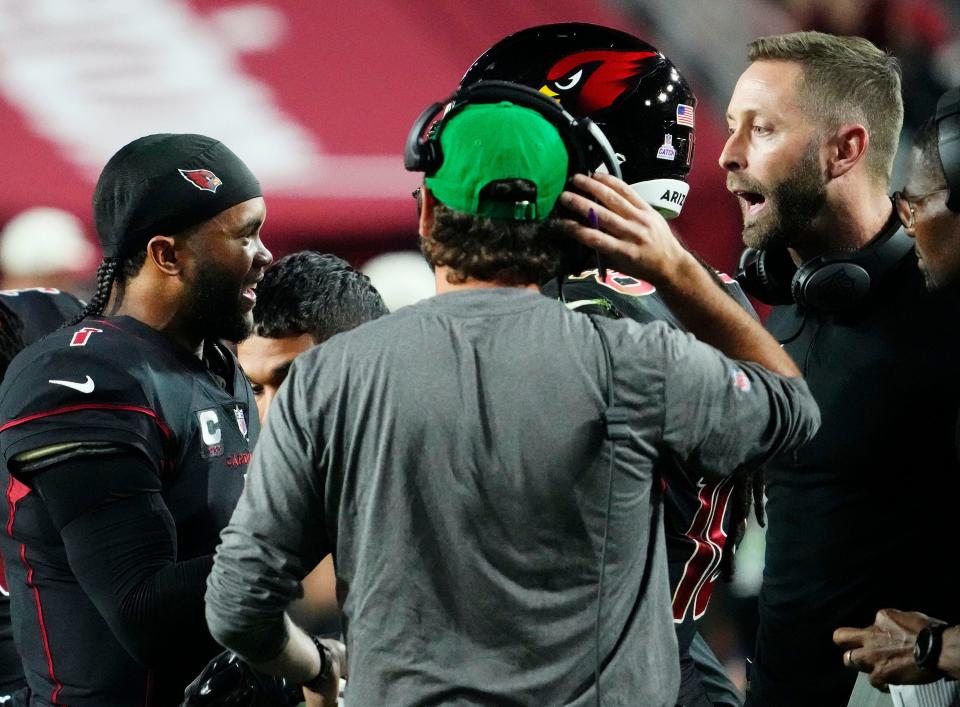 Arizona Cardinals quarterback Kyler Murray (1) and head coach Kliff Kingsbury exchange words during a time out against the New Orleans Saints in the first half at State Farm Stadium.