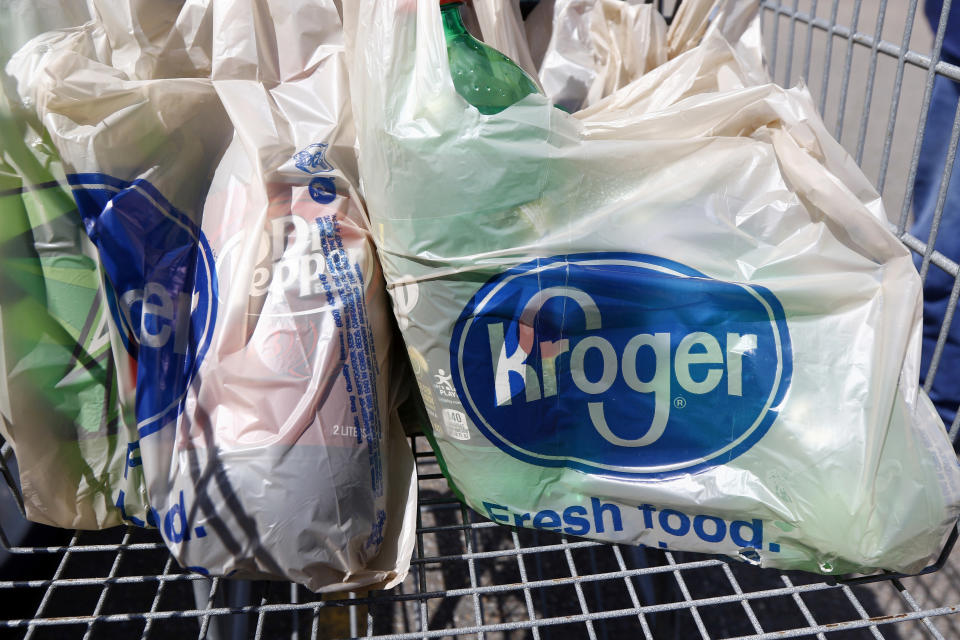 FILE - In this June 15, 2017, file photo, bagged purchases from the Kroger grocery store in Flowood, Miss., sit inside this shopping cart. A group of Instacart workers are organizing a strike across the U.S. starting Monday, March 30, 2020, to demand more pay and protection as they struggle to meet a surge in demand for grocery deliveries during the coronavirus pandemic. It was unclear how many of Instacart's shoppers - most of whom work as independent contractors - would join the strike. (AP Photo/Rogelio V. Solis, File)