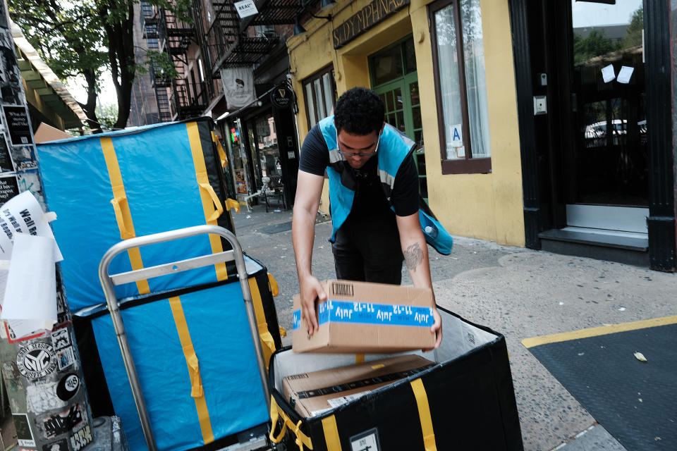 NEW YORK, NEW YORK - JULY 11: An Amazon worker moves boxes on Amazon Prime Day on July 11, 2023 in the East Village of New York City. Amazon holds the annual two-day event, where it offers shopping deals to Prime customers, in the middle of the summer. Amazon Prime Day has brought an estimated 10 billion dollars to the company in each of the last 3 years, as customers look to take advantage of discounts and quick shipping. (Photo by Spencer Platt/Getty Images)
