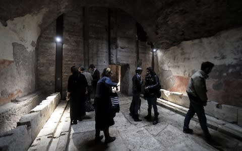 Visitors inspect part of the large 50-seat latrine that was part of Nero's huge palace - Credit: Riccardo Antiminiani/EPA