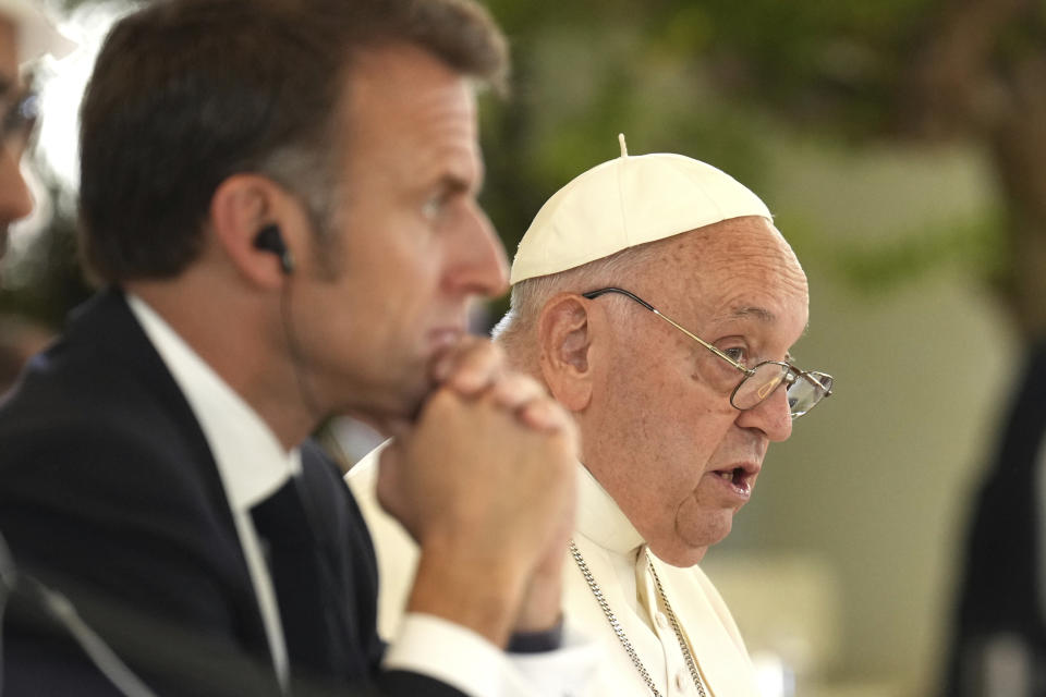 From left, French President Emmanuel Macron, left, listens to Pope Francis speaking during a working session on Artificial Intelligence (AI), Energy, Africa-Mediterranean, on day two of the 50th G7 summit at Borgo Egnazia, southern Italy, on Friday, June 14, 2024. (Christopher Furlong/Pool Photo via AP)