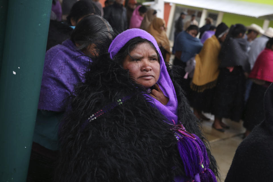 Indigenous Tzotzil women wait to vote in a non-binding national referendum on whether Mexican ex-presidents should be tried for any illegal acts during their time in office, in the Corazon de Maria community of Chiapas state, Mexico, Sunday, Aug. 1, 2021. (AP Photo/Emilio Espejel)