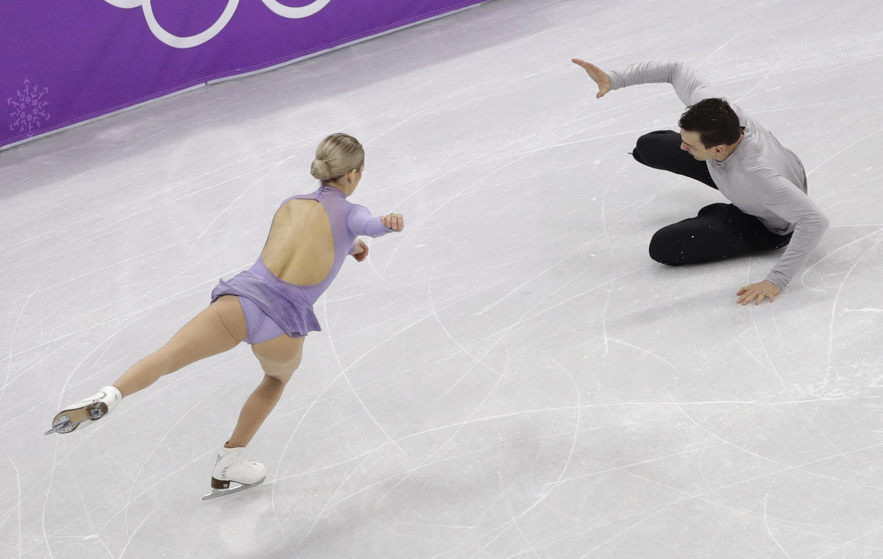 Chris Knierim of the USA falls while performing with partner Alexa Scimeca Knierim in the pairs free skate figure skating final. The Knierims were skating with heavy hearts following a school shooting in Florida. (AP)