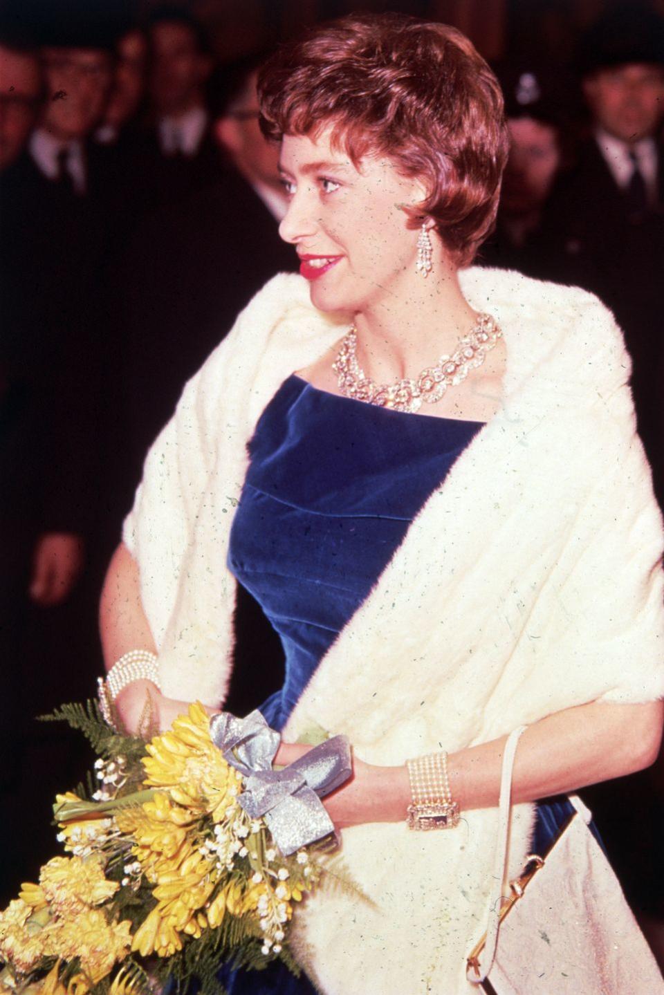 <p>The Princess attends a Royal Command Film Performance in 1961, sporting a fur wrap, a blue gown, and plenty of jewels.</p>