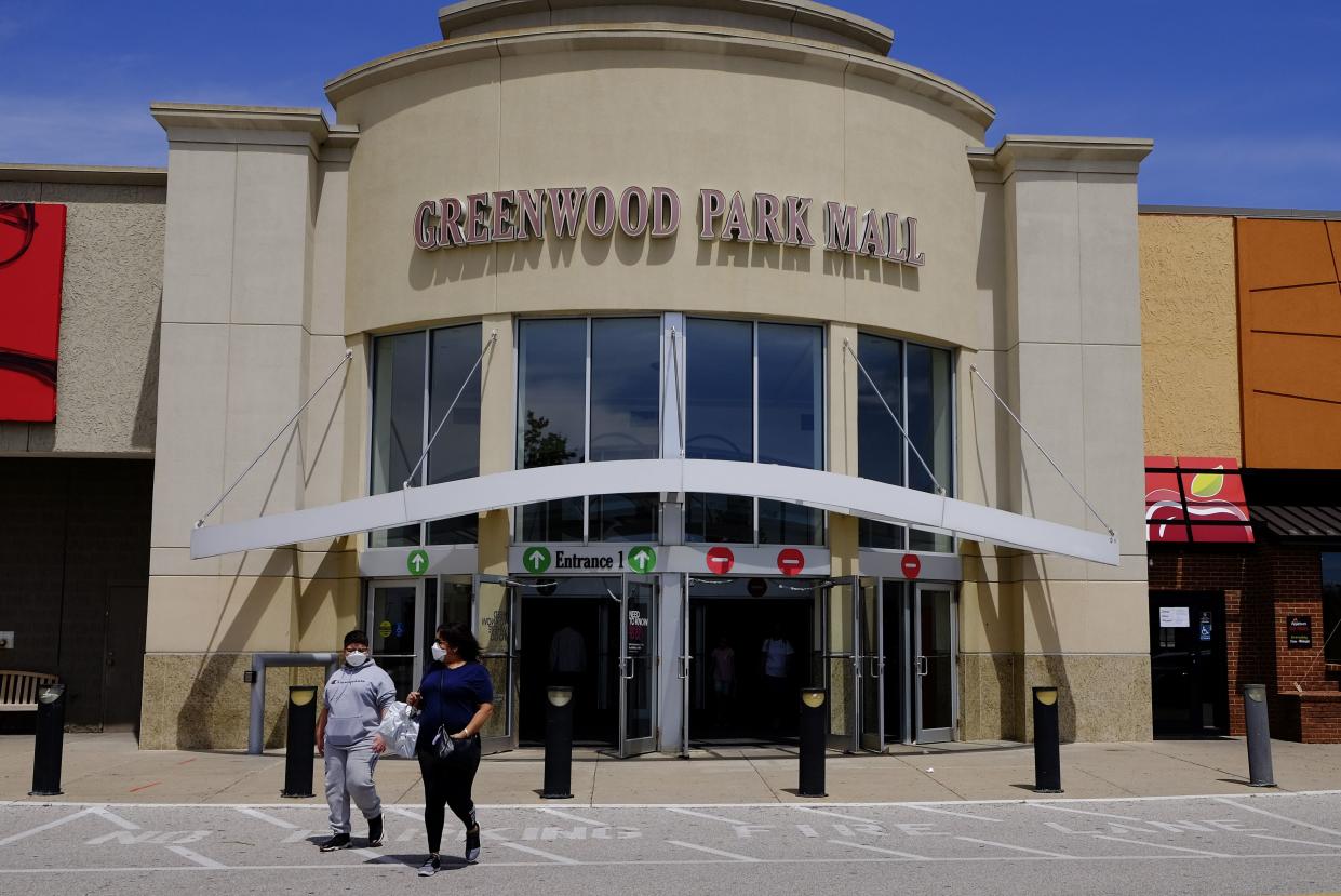 Shoppers leave the Greenwood Park Mall, Monday, May 4, 2020, in Greenwood, Ind.