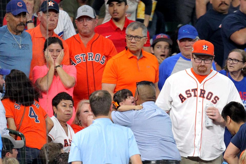 May 29, 2019; Houston, TX, USA; A young fan is taken up to the concourse to receive medical attention after being hit by a foul ball by Chicago Cubs center fielder Albert Almora Jr. (5) during the fourth inning against the Houston Astros at Minute Maid Park. Mandatory Credit: Erik Williams-USA TODAY Sports