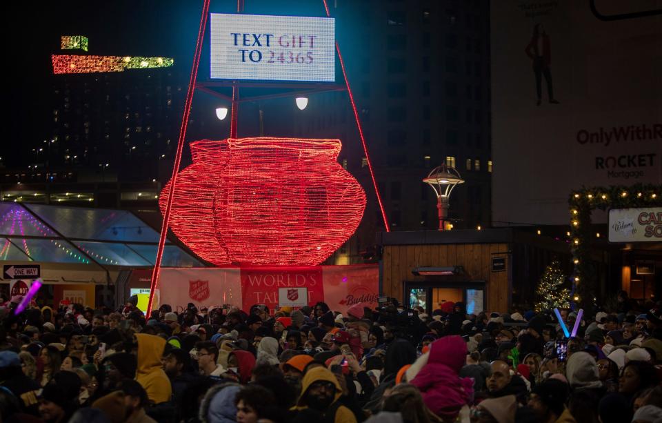 Dozens of people surround the Salvation Army’s giant red kettle during the 20th Annual Tree Lighting in downtown Detroit on Friday, Nov. 17, 2023. The red kettle is made up of 26,000 sparkling LED lights.