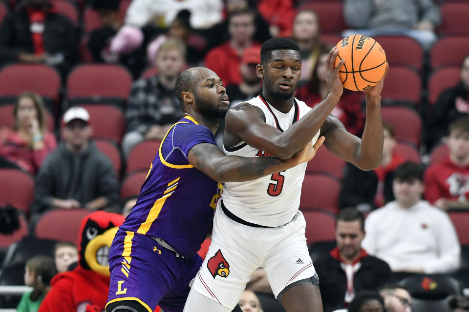 Lipscomb center Ahsan Asadullah (23) attempts to strip the ball away from Louisville forward Brandon Huntley-Hatfield (5) during the first half of an NCAA college basketball game in Louisville, Ky., Tuesday, Dec. 20, 2022. (AP Photo/Timothy D. Easley)