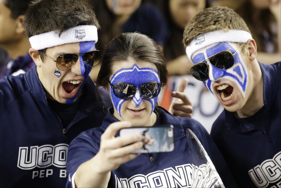 Kentucky fans take a group photo before the NCAA Final Four tournament college basketball championship game against Connecticut Monday, April 7, 2014, in Arlington, Texas. (AP Photo/David J. Phillip)