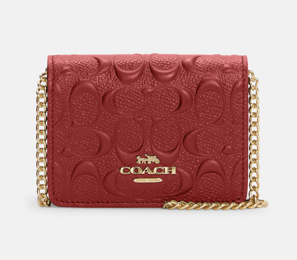 Mini Wallet On A Chain In Signature Leather in red leather (photo via Coach Outlet)