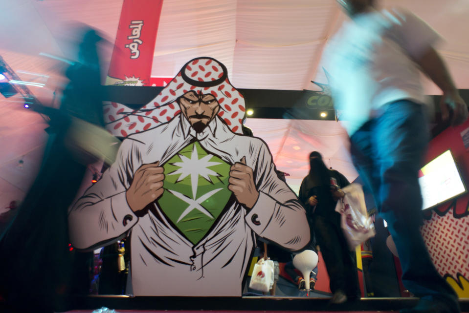 FILE - In this Friday, Feb. 17, 2017, file photo visitors enter Saudi Comic Con (SCC) which is the first event of its kind to be held in Jiddah, Saudi Arabia. Saudi Arabia. The kingdom, which bans movie theaters and other entertainment venues, is challenging its ultraconservative image and loosening the reins on fun by opening its doors to live shows, including some American ones. (AP Photo, File)