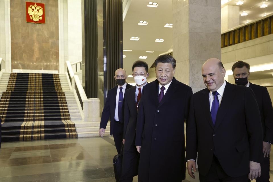 Russian Prime Minister Mikhail Mishustin, right, and Chinese President Xi Jinping walk after their talks in Moscow, Russia, Tuesday, March 21, 2023. (Dmitry Astakhov, Sputnik, Government Pool Photo via AP)