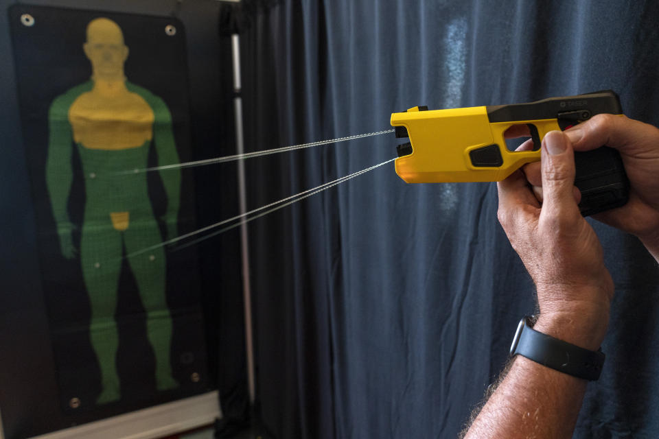 A representative for Axon Enterprise Inc. demonstrates the company's TASER 7 in Washington on Thursday, May 12, 2022. (AP Photo/Jacquelyn Martin)