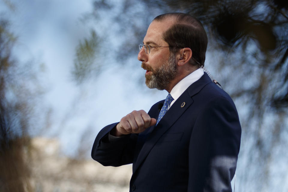 Health and Human Services Secretary Alex Azar demonstrates how to greet others with an elbow as he speaks during a television interview outside the West Wing of the White House in Washington, Monday, March, 9, 2020. (AP Photo/Carolyn Kaster)