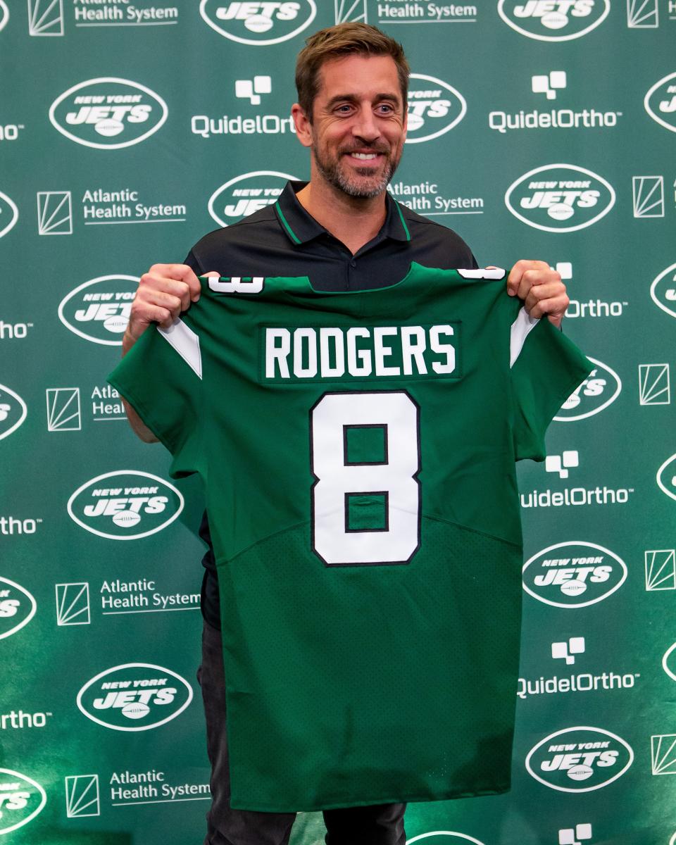 New New York Jets QB Aaron Rodgers shows off his new jersey and number at Wednesday's introductory press conference.