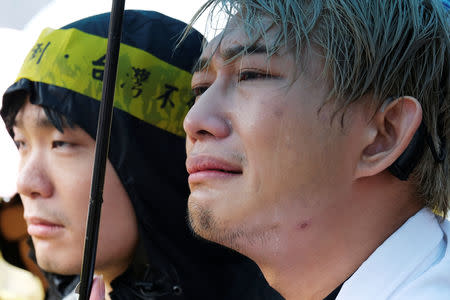 A same-sex marriage supporter cries during a parliament vote on three draft bills of a same-sex marriage law, outside the Legislative Yuan in Taipei, Taiwan May 17, 2019. REUTERS/Tyrone Siu