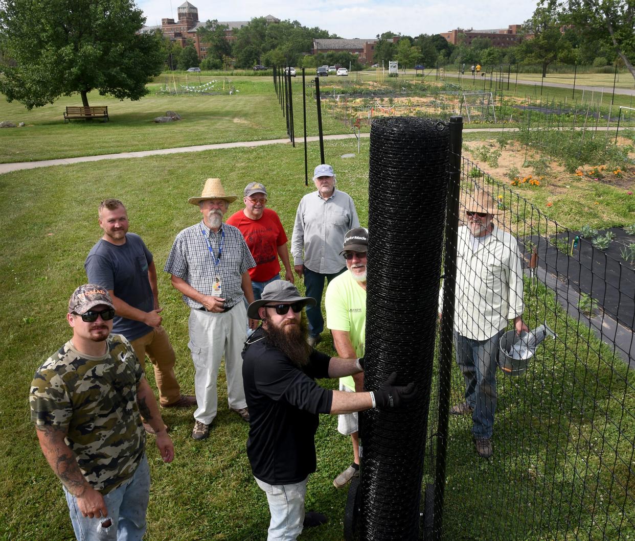 To keep deer away, this group helped erect a seven-foot fence around the St. Mary's organic garden on the property of the Sisters, Servants Immaculate Heart of Mary. The deer were eating the 30 gardeners' produce causing some gardeners to give up on the plots. The workers photographed here include St. Mary's Organic Farm garden coordinator Bob Dluzen (straw hat center left) along with Jail Alternative Work Service (JAWS) members Nick Vanwasshenova, Zach Messer, Anthony Tunison and volunteers Dan Poirier, Dave Gelwicks, Paul Simonton and Bob Peven.