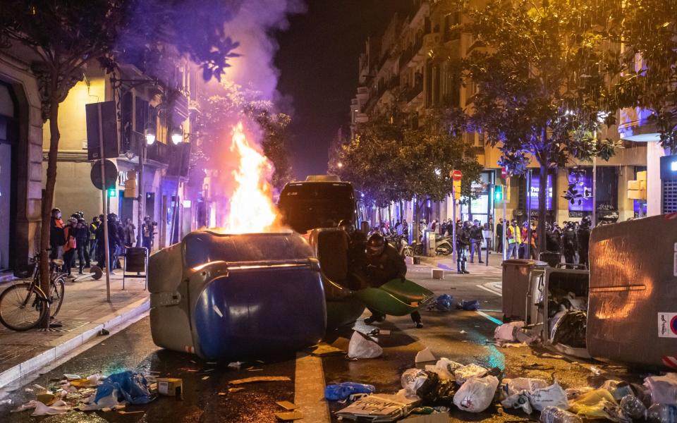 Members of the Catalan police remove barricades during protest for the freedom of Pablo Hasel on Saturday - Getty