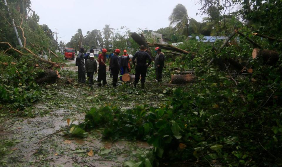 Workers cut up trees felled by Hurricane Iota on San Andres island, Colombia. Iota moved over the Colombian archipelago of San Andres, Providencia and Santa Catalina, off Nicaragua’s coast, as a Category 5 hurricane.