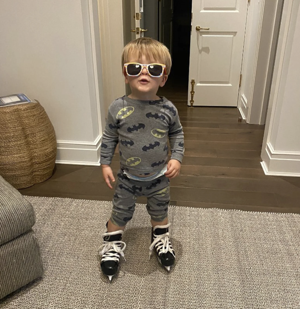 carrie underwood's son jacob fisher in ice skates and sunglasses