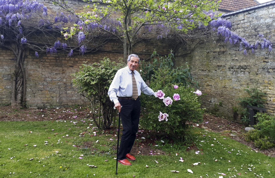 In this photo taken on Friday, April 17, 2020, World War II and D-Day veteran Charles Norman Shay, from Maine, poses in the garden of his house in Bretteville-l'Orgueilleuse, Normandy, France. Instead of parades, remembrances, embraces and one last great hurrah for veteran soldiers who are mostly in their nineties to celebrate VE Day, it is instead a lockdown due to the coronavirus, COVID-19. (Marie-Pascale Legrand via AP)