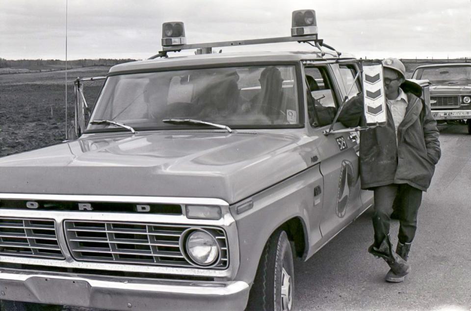 FILE- Department of Transportation officials wait during the halt of Interstate construction May 1976 by protesters in Sheboygan County.