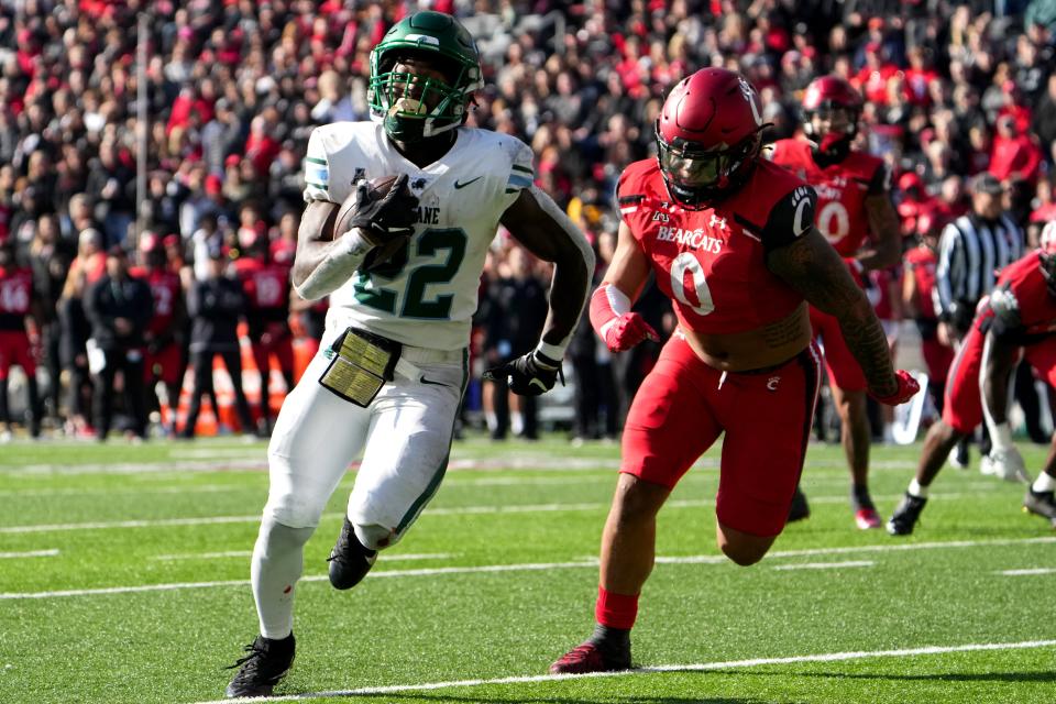 Tulane running back Cameron Carroll (20) beats Cincinnati Bearcats linebacker Ivan Pace Jr. to the end zone for a touchdown during their game, Friday, Nov. 25, 2022, at Nippert Stadium in Cincinnati.