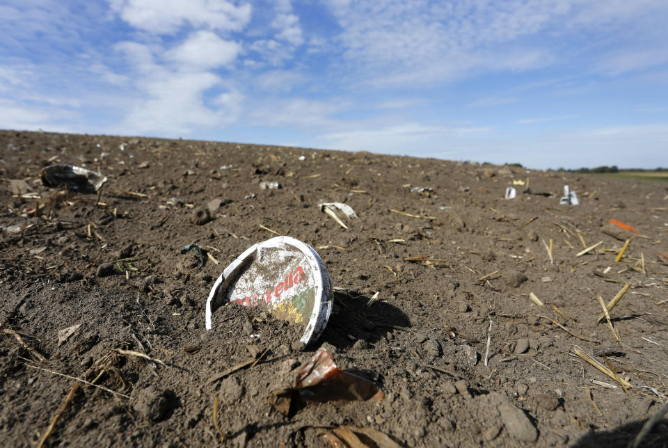 In this Sept. 9, 2018 photo plastic waste sits on a freshly cultivated field in Nauen, Germany. Scientists in Austria say they've detected tiny bits of plastic in people's stool for the first time, but experts caution the study is too small and premature to draw any credible conclusion. (AP Photo/Ferdinand Ostrop)