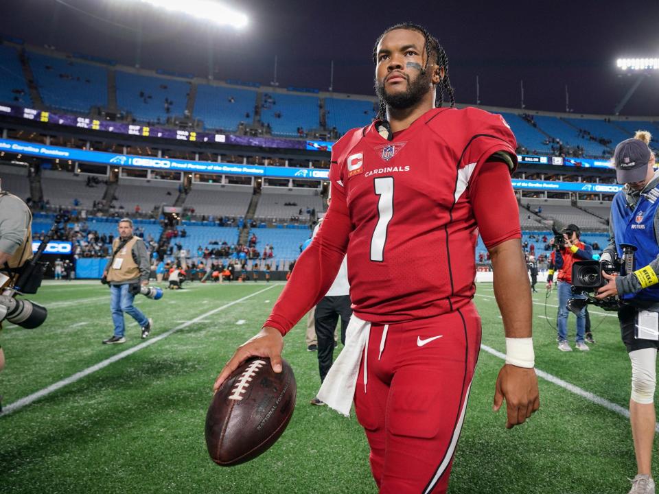 Kyler Murray walks off the field after a win against the Carolina Panthers.