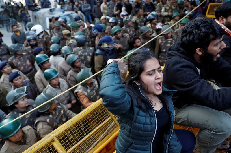 Demonstrators shout slogans during a protest against a new citizenship law outside the Jamia Millia Islamia university in New Delhi