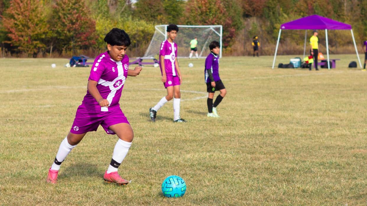 Levi Lozada kicks a soccer ball along with his Naptown United teammates.