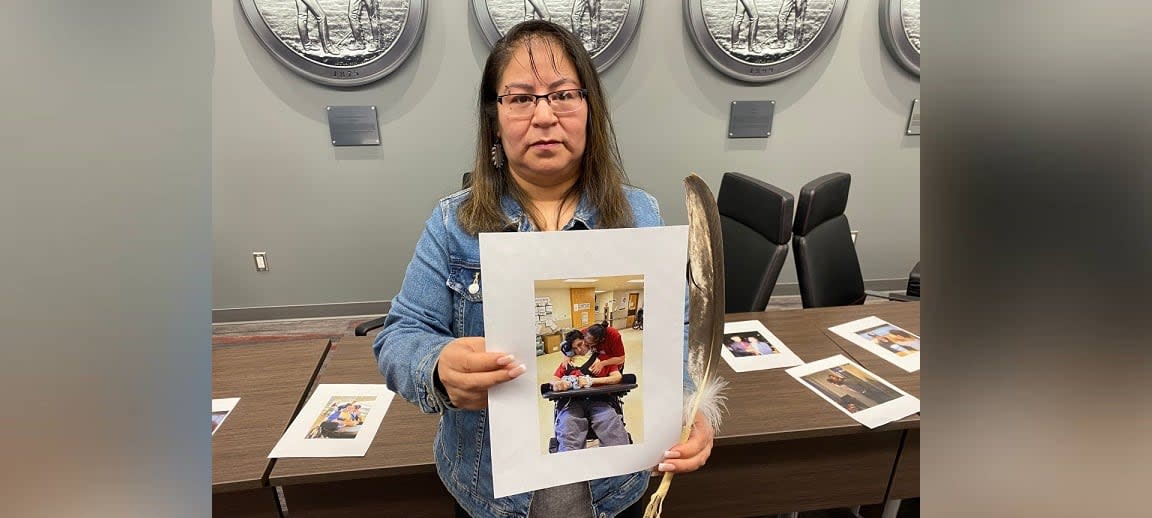 Charlene Fineday holds a picture of her son Darnell Fineday, who was strong and healthy only a year ago and is now paralyzed after being hit by a drunk driver. (Jason Warick/CBC - image credit)