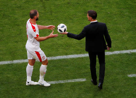 Soccer Football - World Cup - Group E - Costa Rica vs Serbia - Samara Arena, Samara, Russia - June 17, 2018 Serbia coach Mladen Krstajic gives the ball to Branislav Ivanovic REUTERS/David Gray