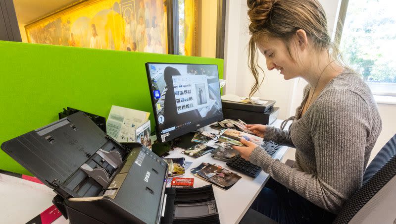 Lena Nauta, 17, organizes hundreds of pictures at the Family Memories Preservation Center in the FamilySearch Library in Salt Lake City on June 26, 2023. The center, located on the second floor of the library, is now open and free to the public.