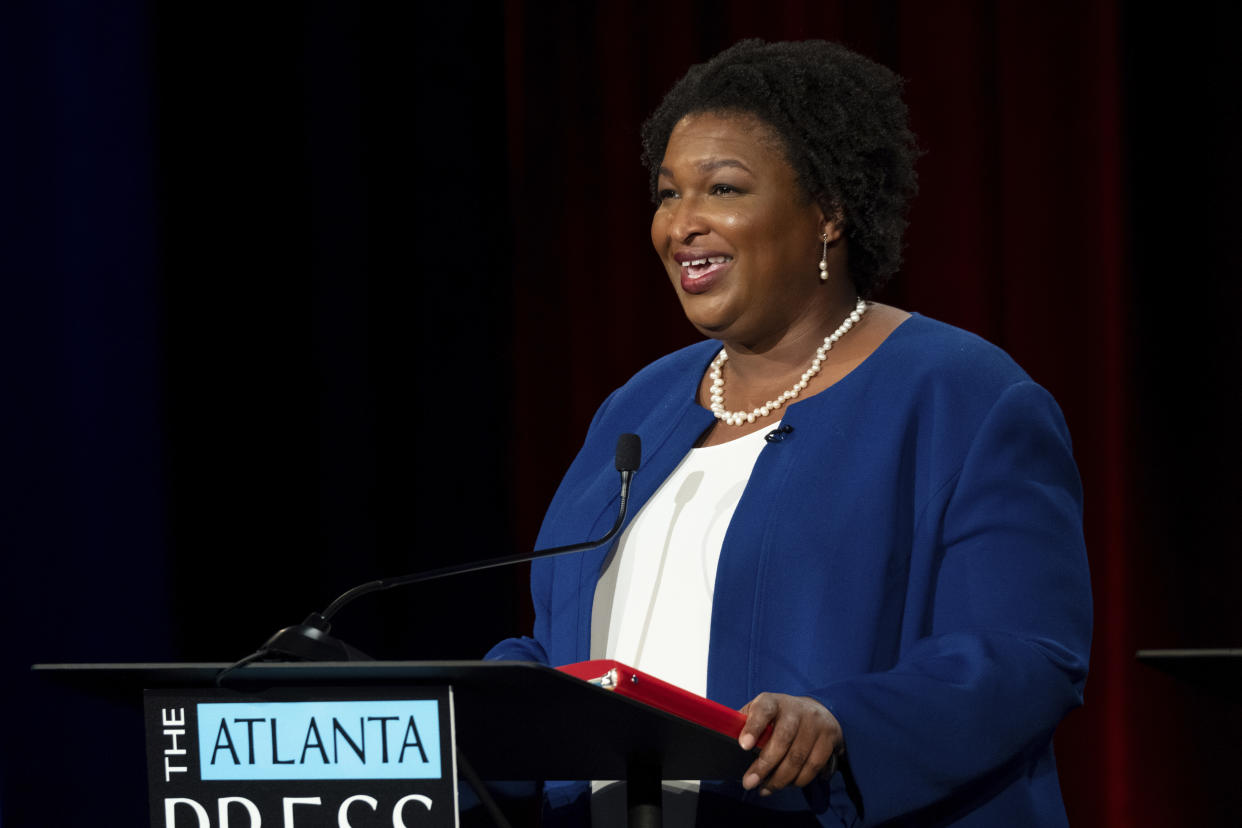 Stacey Abrams stands at a podium.